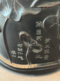 A Chinese ebonized wooden brush pot with relief design of lotus flowers and an inscription, 20th C.