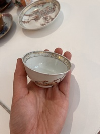 Six Chinese famille rose and gilt cups and saucers and a cream jug with floral and mandarin design, Yongzheng/Qianlong