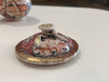 Six Chinese famille rose and gilt cups and saucers and a cream jug with floral and mandarin design, Yongzheng/Qianlong