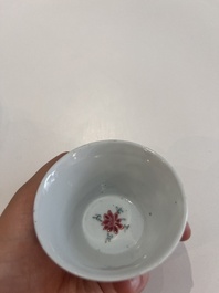 Six Chinese famille rose and gilt cups and saucers and a cream jug with floral and mandarin design, Yongzheng/Qianlong