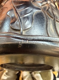 A Chinese ebonized wooden brush pot with relief design of lotus flowers and an inscription, 20th C.