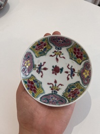 Six Chinese famille rose and gilt cups and saucers and a cream jug with floral and mandarin design, Yongzheng/Qianlong