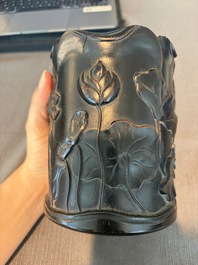 A Chinese ebonized wooden brush pot with relief design of lotus flowers and an inscription, 20th C.
