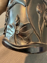 A Chinese ebonized wooden brush pot with relief design of lotus flowers and an inscription, 20th C.