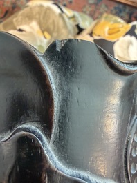 A Chinese ebonized wooden brush pot with relief design of lotus flowers and an inscription, 20th C.