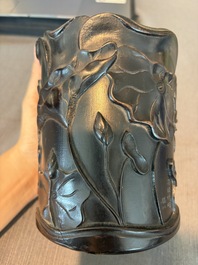 A Chinese ebonized wooden brush pot with relief design of lotus flowers and an inscription, 20th C.