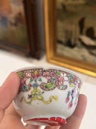 Six Chinese famille rose and gilt cups and saucers and a cream jug with floral and mandarin design, Yongzheng/Qianlong