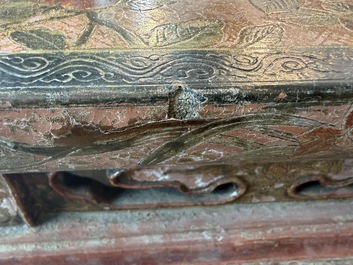 A Chinese rectangular carved and lacquered wooden low table with peach design, Qing