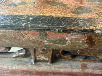 A Chinese rectangular carved and lacquered wooden low table with peach design, Qing