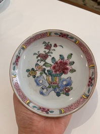 Six Chinese famille rose and gilt cups and saucers and a cream jug with floral and mandarin design, Yongzheng/Qianlong