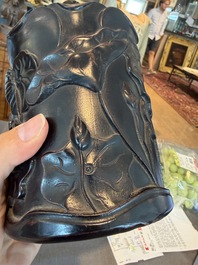 A Chinese ebonized wooden brush pot with relief design of lotus flowers and an inscription, 20th C.