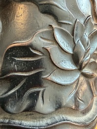 A Chinese ebonized wooden brush pot with relief design of lotus flowers and an inscription, 20th C.