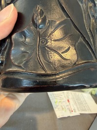 A Chinese ebonized wooden brush pot with relief design of lotus flowers and an inscription, 20th C.