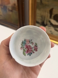 Six Chinese famille rose and gilt cups and saucers and a cream jug with floral and mandarin design, Yongzheng/Qianlong