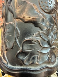 A Chinese ebonized wooden brush pot with relief design of lotus flowers and an inscription, 20th C.