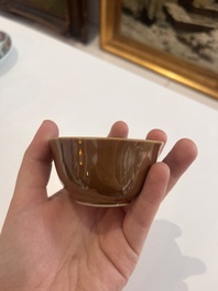 Six Chinese famille rose and gilt cups and saucers and a cream jug with floral and mandarin design, Yongzheng/Qianlong