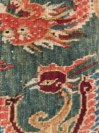 A Tibetan wool 'dragons and phoenixes' rug, 19th C.