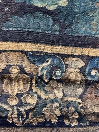 A Flemish wall tapestry with birds in a landscape with a castle in the background, 17th C.