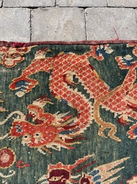 A Tibetan wool 'dragons and phoenixes' rug, 19th C.
