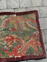 A Tibetan wool 'dragons and phoenixes' rug, 19th C.