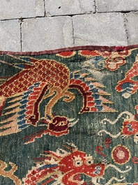 A Tibetan wool 'dragons and phoenixes' rug, 19th C.