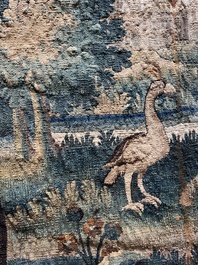A Flemish wall tapestry with birds in a landscape with a castle in the background, 17th C.