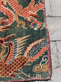 A Tibetan wool 'dragons and phoenixes' rug, 19th C.