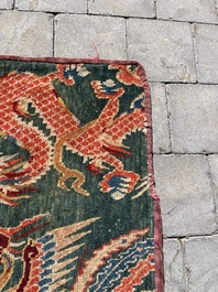 A Tibetan wool 'dragons and phoenixes' rug, 19th C.