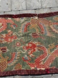A Tibetan wool 'dragons and phoenixes' rug, 19th C.