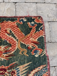 A Tibetan wool 'dragons and phoenixes' rug, 19th C.