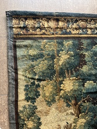 A Flemish wall tapestry with birds in a landscape with a castle in the background, 17th C.