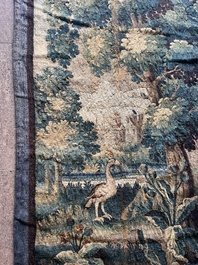 A Flemish wall tapestry with birds in a landscape with a castle in the background, 17th C.