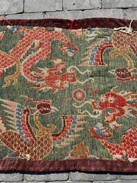A Tibetan wool 'dragons and phoenixes' rug, 19th C.