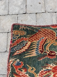 A Tibetan wool 'dragons and phoenixes' rug, 19th C.