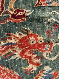 A Tibetan wool 'dragons and phoenixes' rug, 19th C.