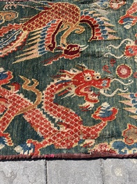 A Tibetan wool 'dragons and phoenixes' rug, 19th C.