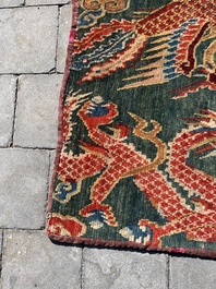 A Tibetan wool 'dragons and phoenixes' rug, 19th C.