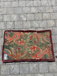 A Tibetan wool 'dragons and phoenixes' rug, 19th C.