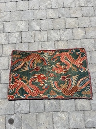 A Tibetan wool 'dragons and phoenixes' rug, 19th C.