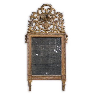 A French gilt wooden Louis XVI mirror with the symbol of fidelity and love and floral design, 18th C.