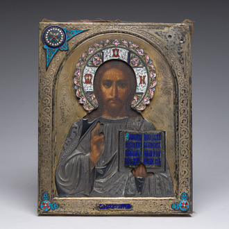 A Russian orthodox 'Christ Pantocrator' icon with partly enamelled gilt silver oklad or riza, 19th/20th C.