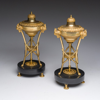 A pair of French gilt bronze Louis XVI candlesticks-cassolettes with acanthus leaves and ram's heads on a black marble base, late 18th C.