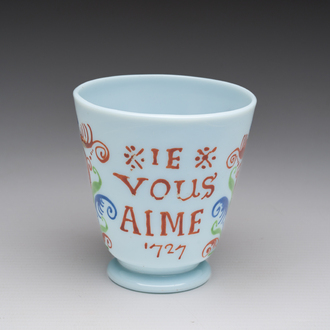 A French polychrome decorated opaline glass 'Je vous aime' (I love you) cup in the manner of Bernard Perrot (Orléans), dated 1727