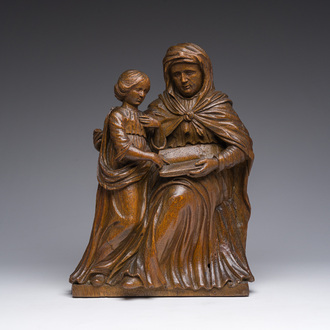A Flemish oak group depicting Saint Anne teaching Mary to read, 19th C.