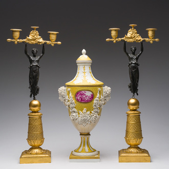 A pair of French partly gilt and patinated bronze candlesticks and a Sèvres style vase and cover with floral relief design, 20th C.