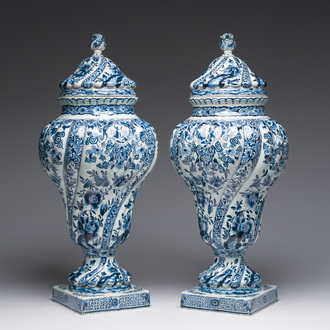 A pair of impressive blue and white Dutch Delft twisted vases and covers, 19th C.