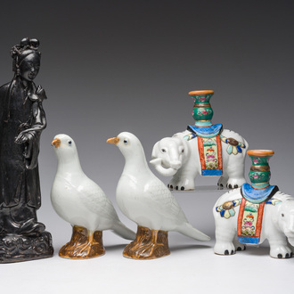 A pair of Chinese porcelain pigeons, a pair of elephant candlesticks and a black-glazed female, 19th/20th C.