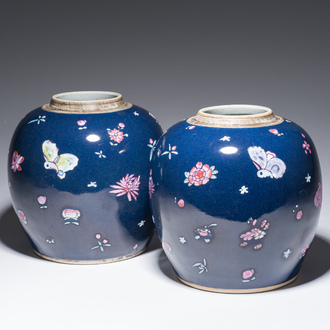 A pair of Chinese blue ground jars with enamelled decoration of butterflies and flowers, 19th C.