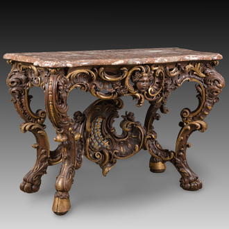 An impressive parcel-gilt and patinated wooden console in Rococo style, probably Italy, 19th C.