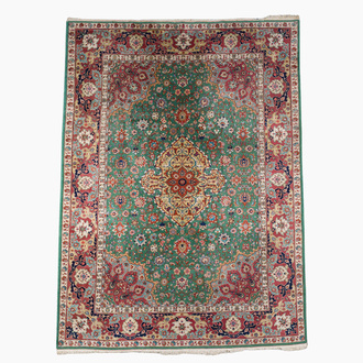 A Persian Tabriz rug with floral design, wool on cotton, first half 20th C.